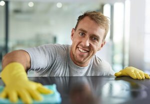 Man cleaning table top